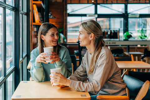 Two women enjoying coffee in a quaint coffee shop