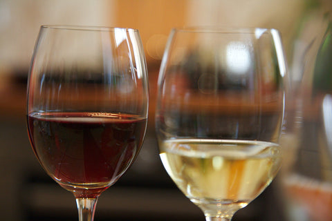 Two wine glasses with red and white wine. 