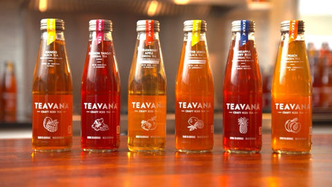 6 Teavana iced tea bottles on a wood table.