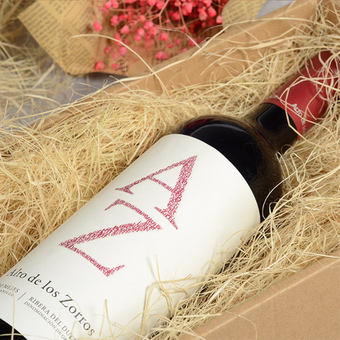 AZ wine bottle on basket filler in a box.