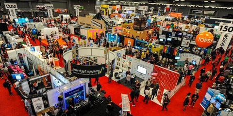 Busy convention center with booths.