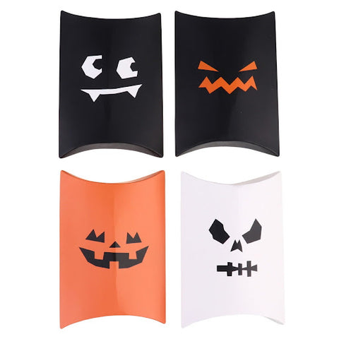 Four Halloween candy boxes with jack-o'-lantern faces in combinations of black, white, and orange