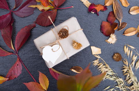 Gift box on fall-decorated table