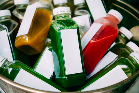 unlabeled square bottles with brightly colored liquid