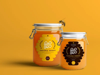 Honey jars with custom labels with orange background.