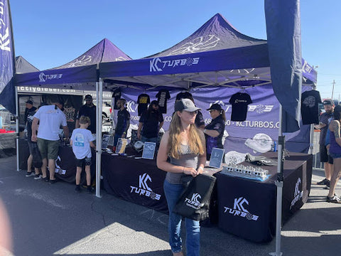 KC Turbos custom canopy tents, walls, and feather flag at outdoor event.