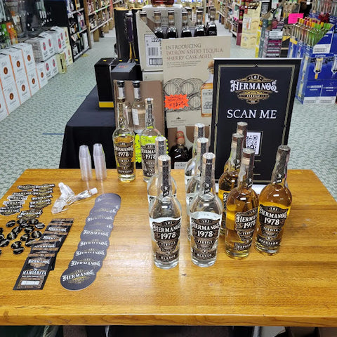 Los Hermanos Tequila table setup at liquor store.
