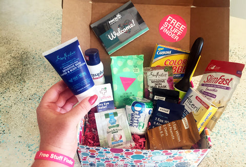 Open Free Stuff Finder box with woman's hand picking up a body lotion.
