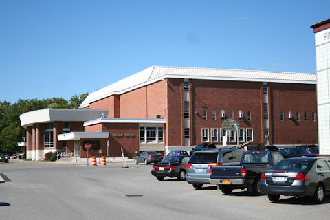 School parking lot in front of brick building.