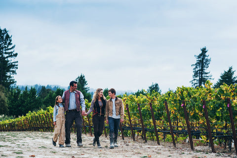 Sloan family walking on vineyard. 