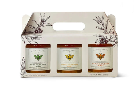 Three honey jars in a custom box with labels.