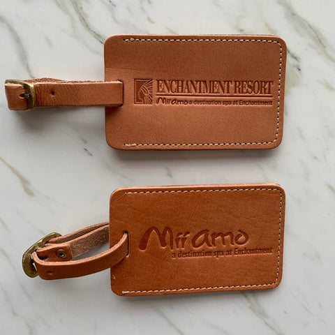 Two brown leather luggage tags.