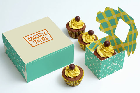 Two cupcake boxes and four cupcakes.