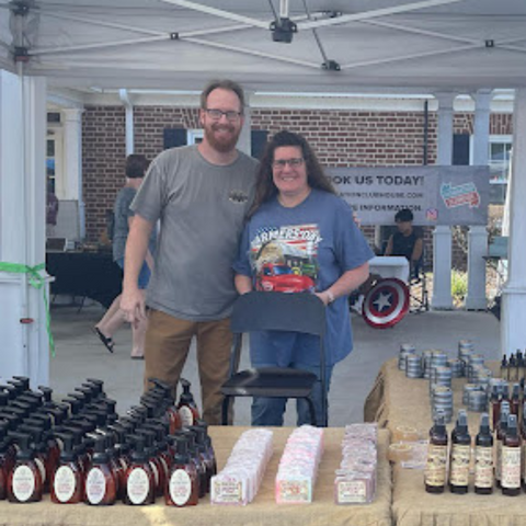 Owners standing with soap products.