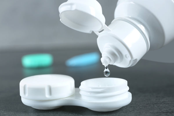 Contact lens solution is dropped into a contact lens case