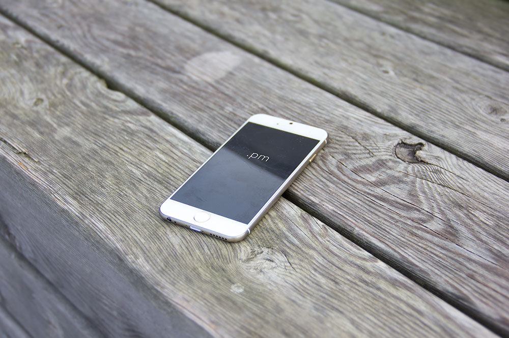 Download White Iphone 6 On A Wooden Table Psd Mockup Mockup Hunt