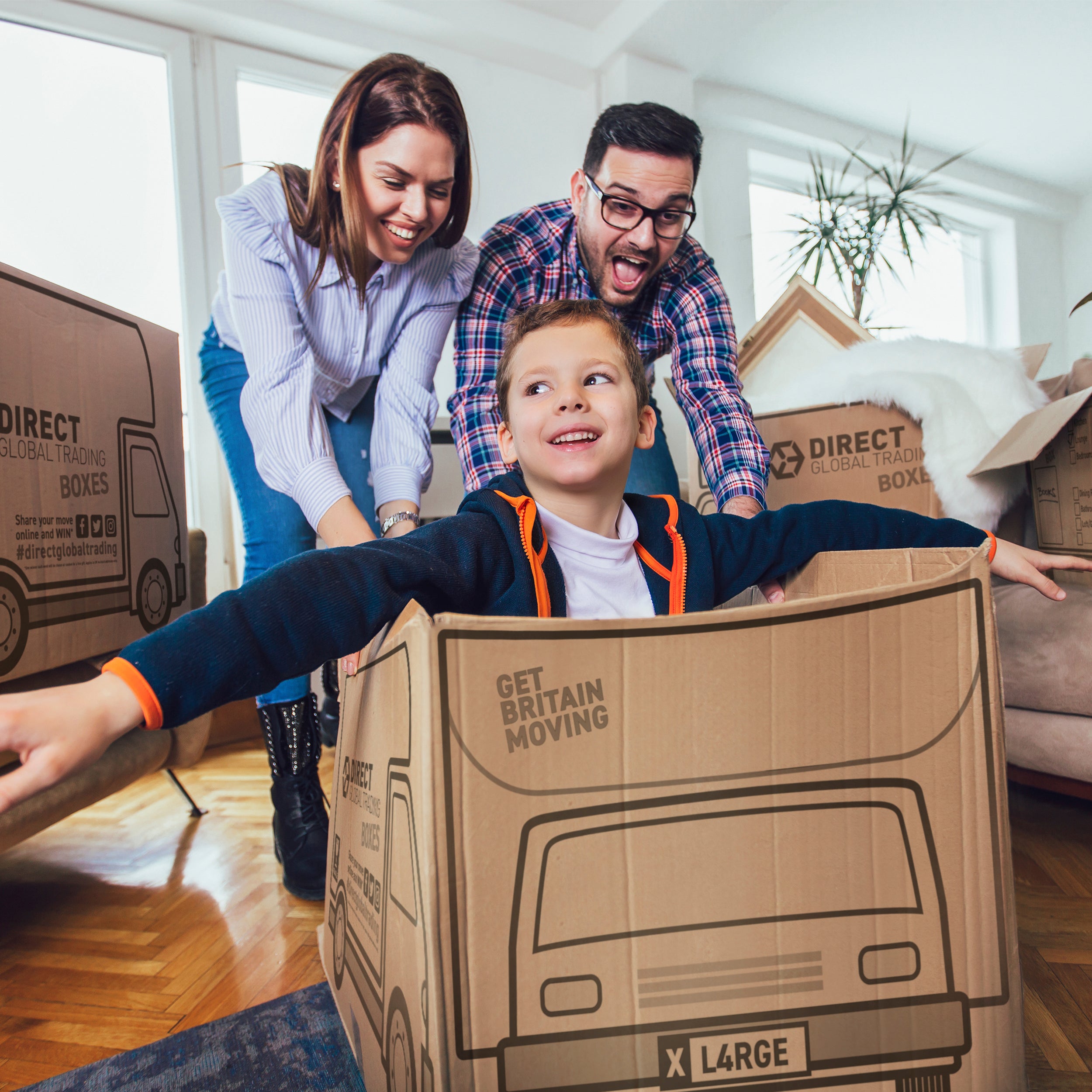 family playing with cardboard boxes