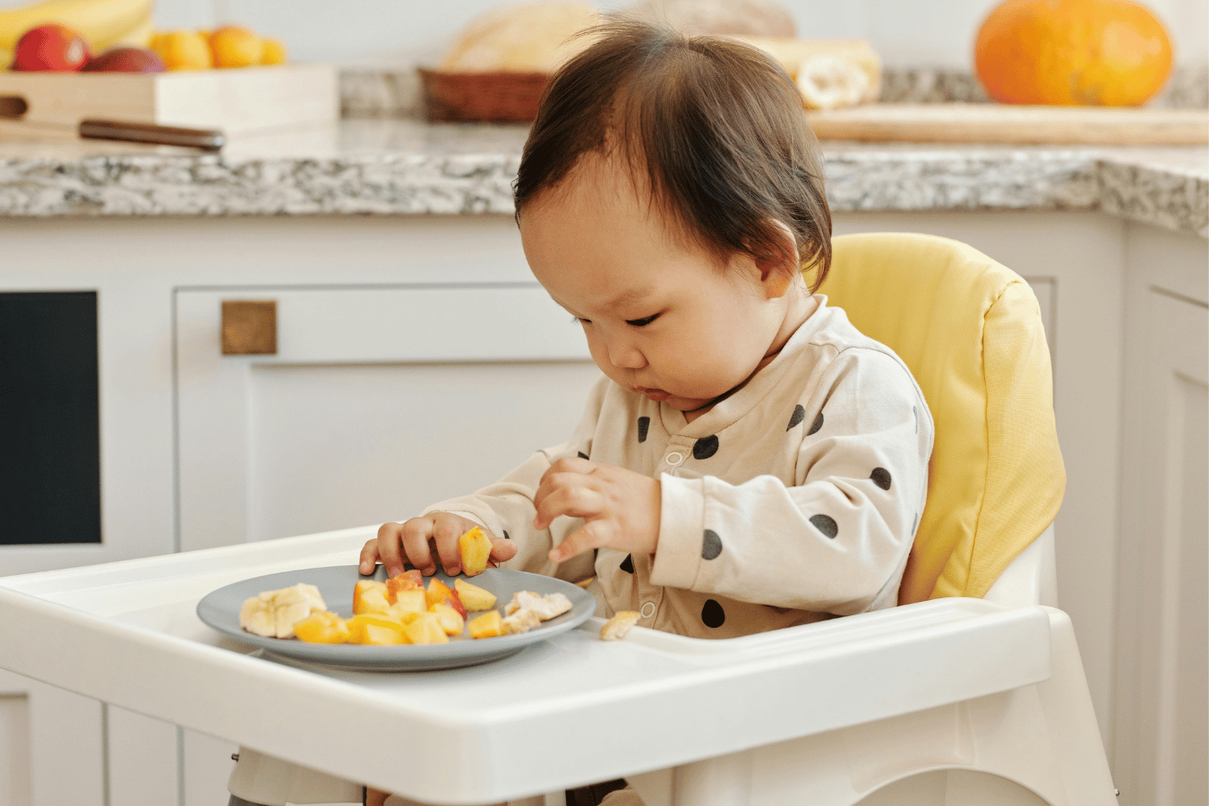 baby eating at highchair-reusable baby bottle labels- Mila's Keeper