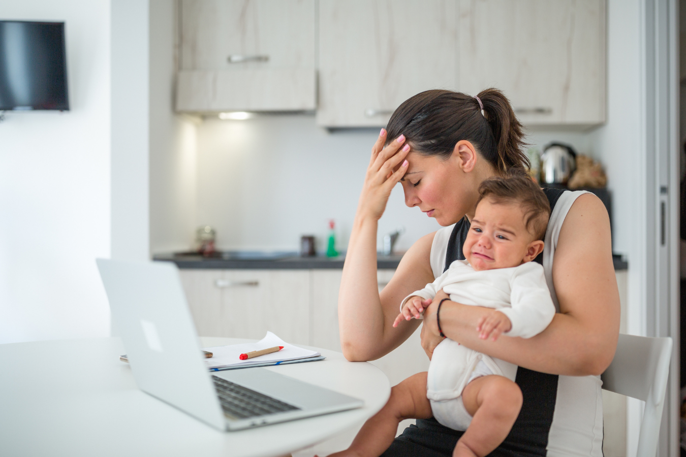 upset mom holding baby- what is a nursing strike- Mila's Keeper