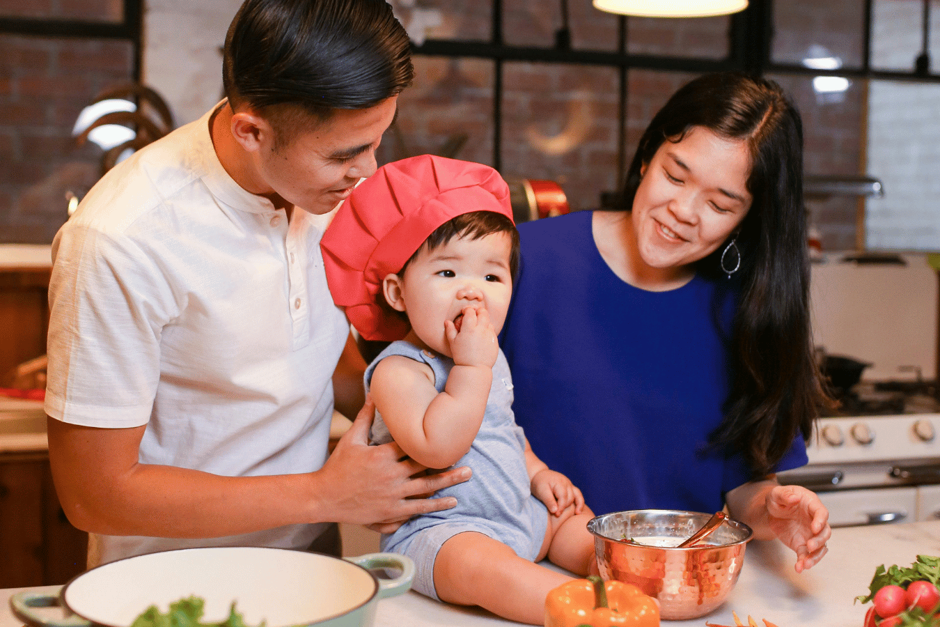 family with baby in kitchen with food-how to start baby led weaning- Mila's Keeper