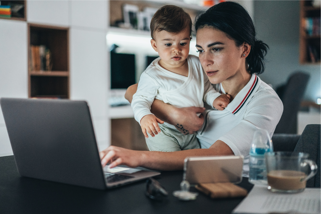 Mother and child look at laptop-how much water should you drink while breastfeeding- Mila's Keeper