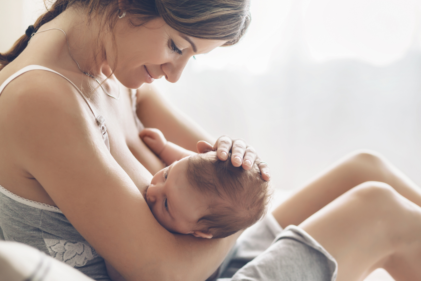 woman nursing baby-can you mix formula and breastmilk -Mila's Keeper