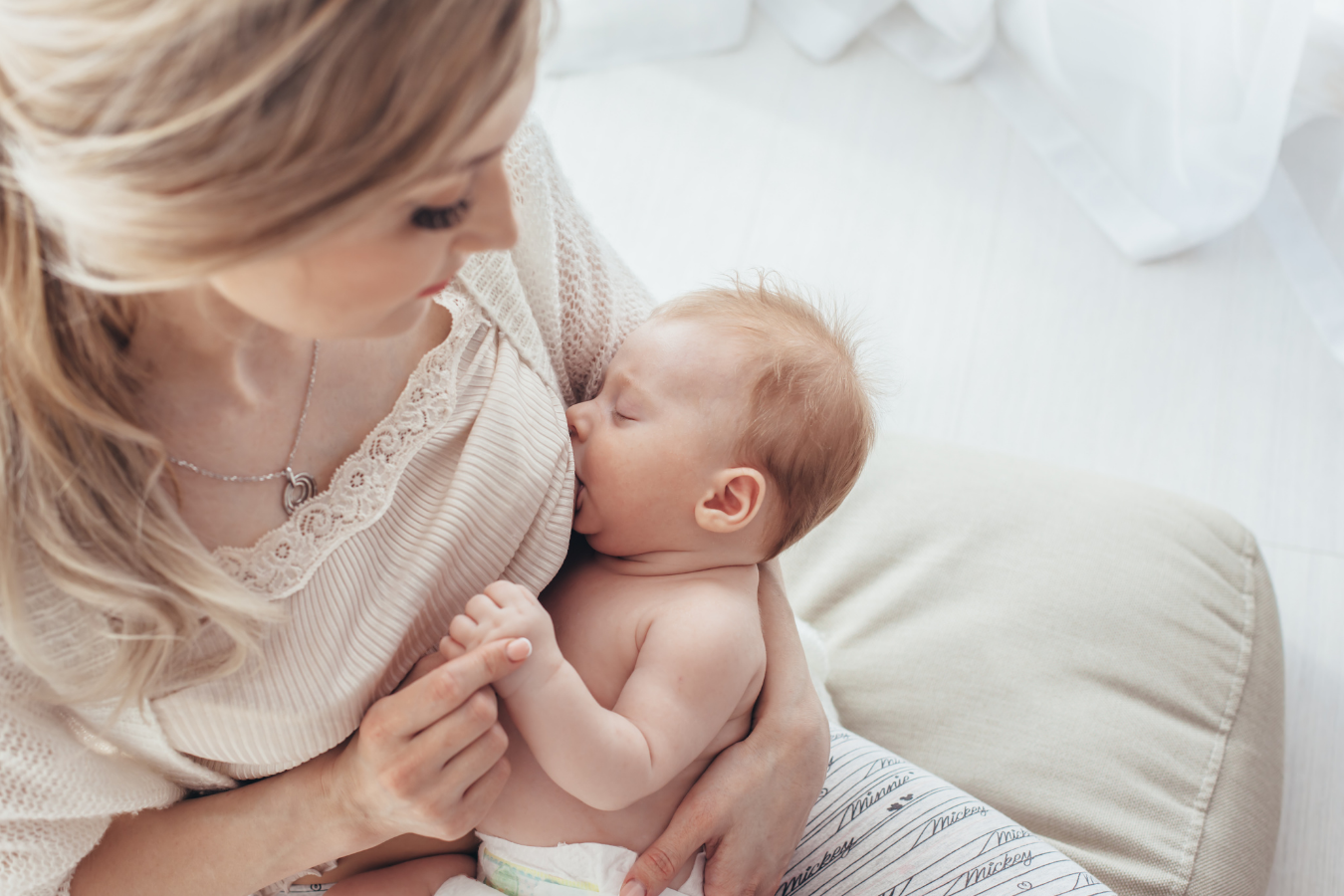 woman nursing baby-Breast Milk Jewelry- how long does breast milk jewelry last-Mila's Keeper