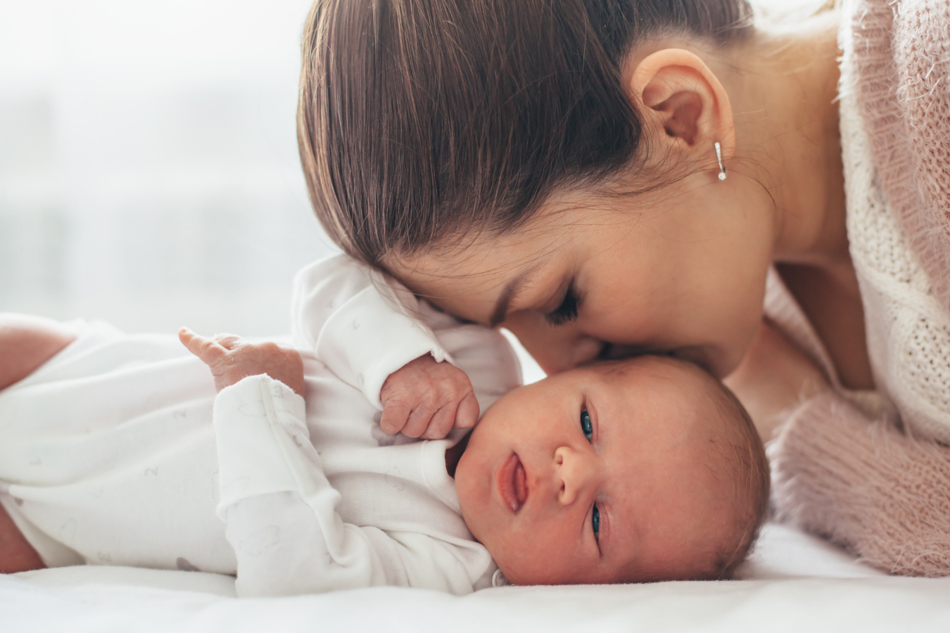 mother kisses baby- Creating a Pumping and Breastfeeding Schedule -Mila's Keeper