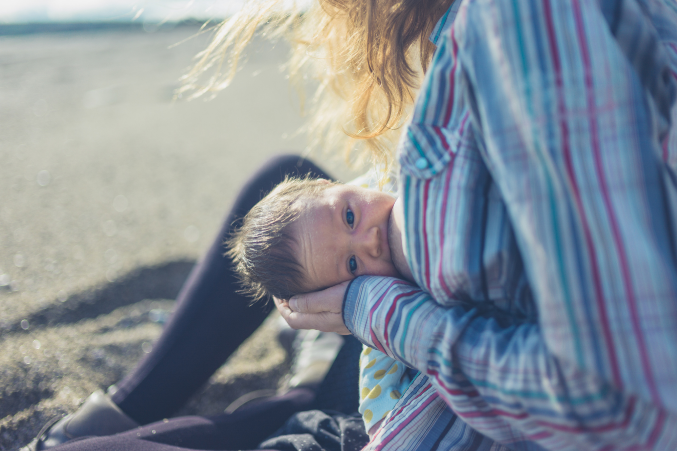 mother breastfeeds baby outside- Pumping After Breastfeeding-Mila's Keeper