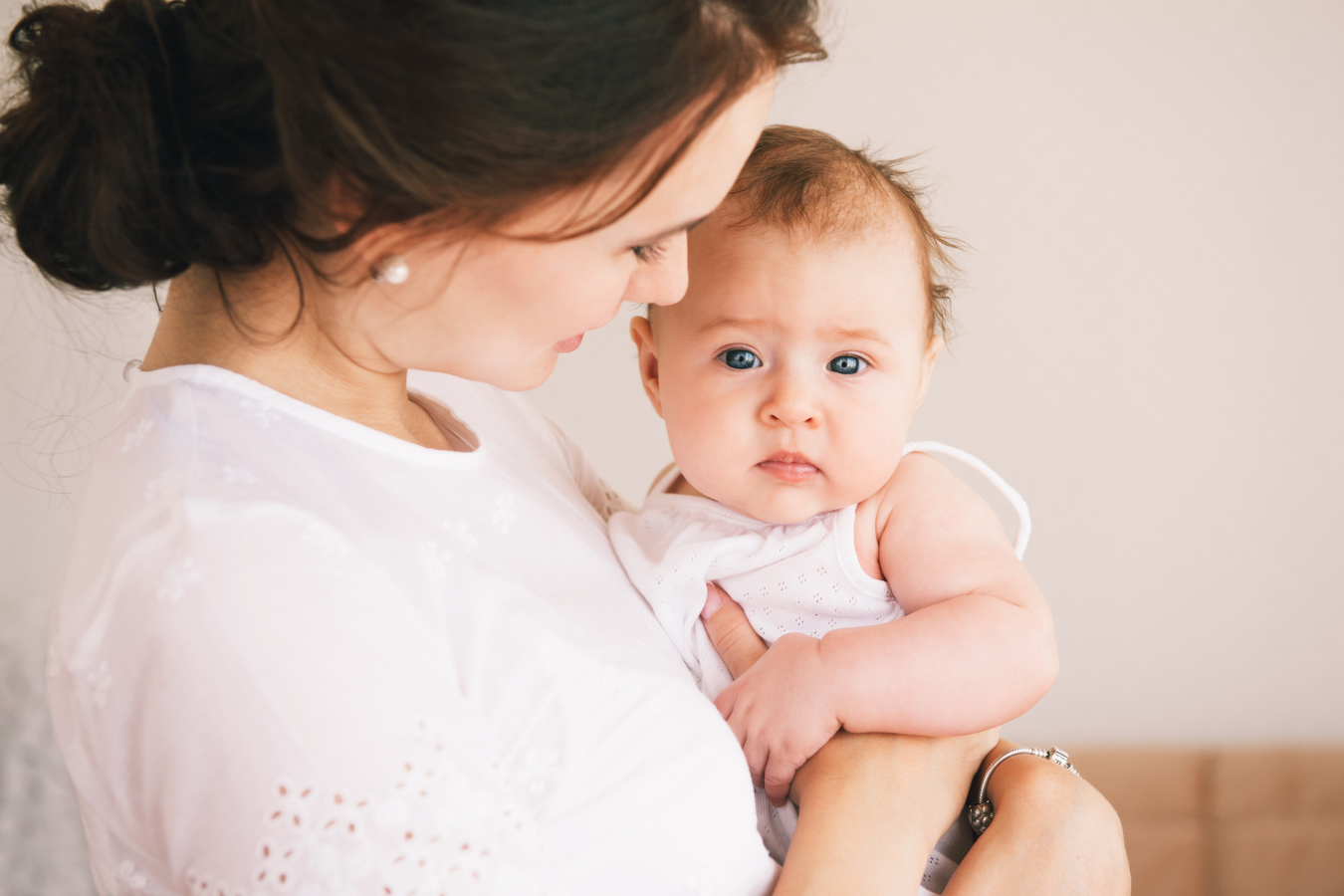 woman holds baby-pregnant while breastfeeding- Mila's Keeper