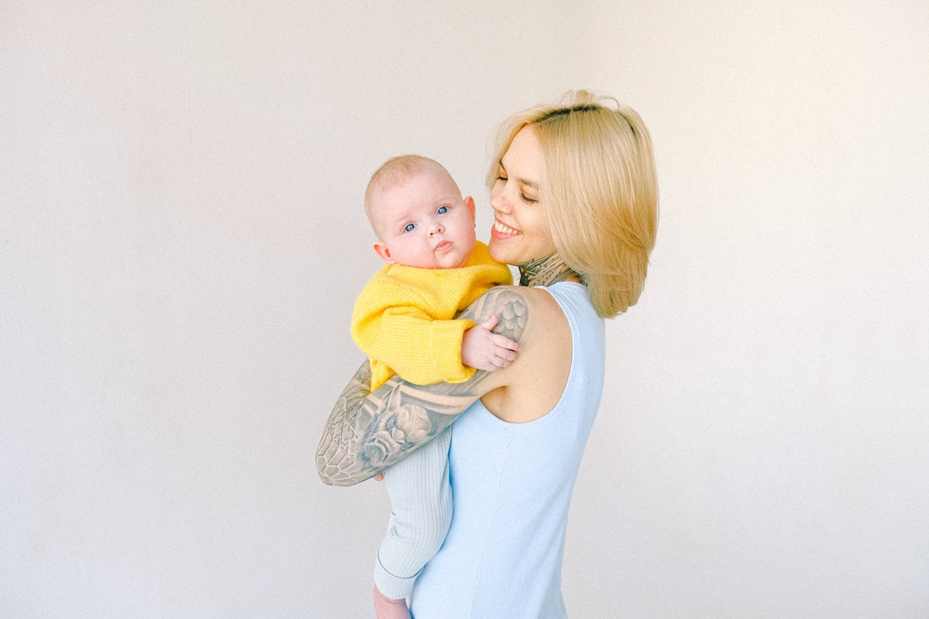 mom holding baby/can-you-get-a-tatoo-while-breastfeeding