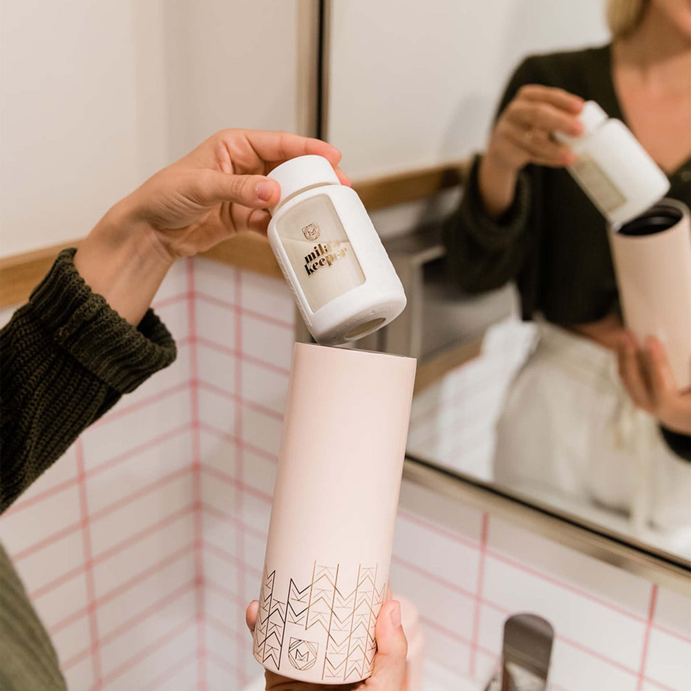 Mila's Keeper Insulated Breast Milk Cooler used for storing breast milk in bathroom.