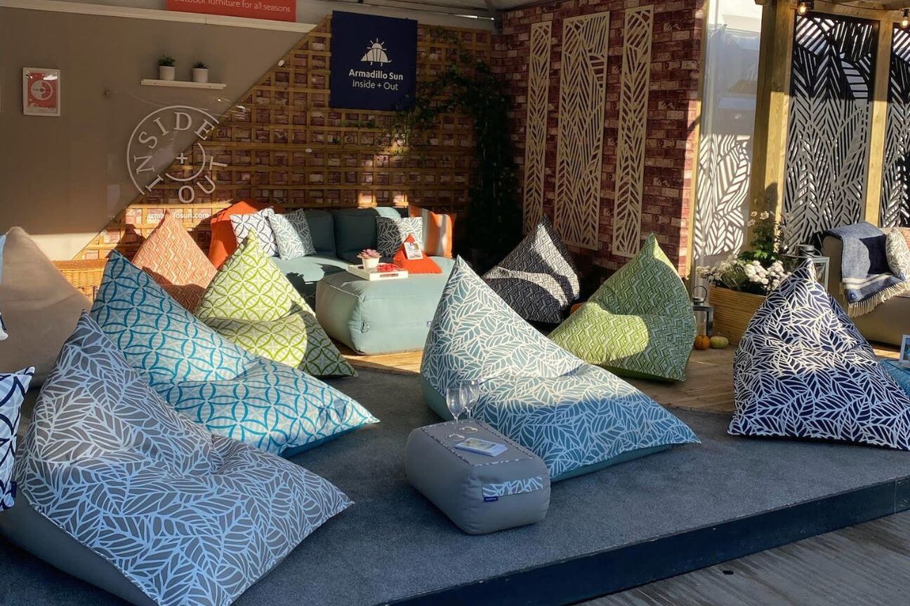 Colourful patterned outdoor bean bags set out on an exhibitors stand