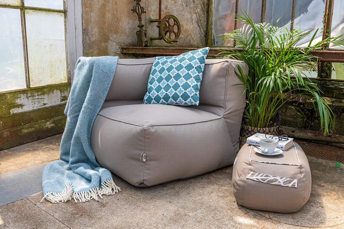 A garden sofa corner chair placed inside offers a cosy corner for a quiet cup of coffee