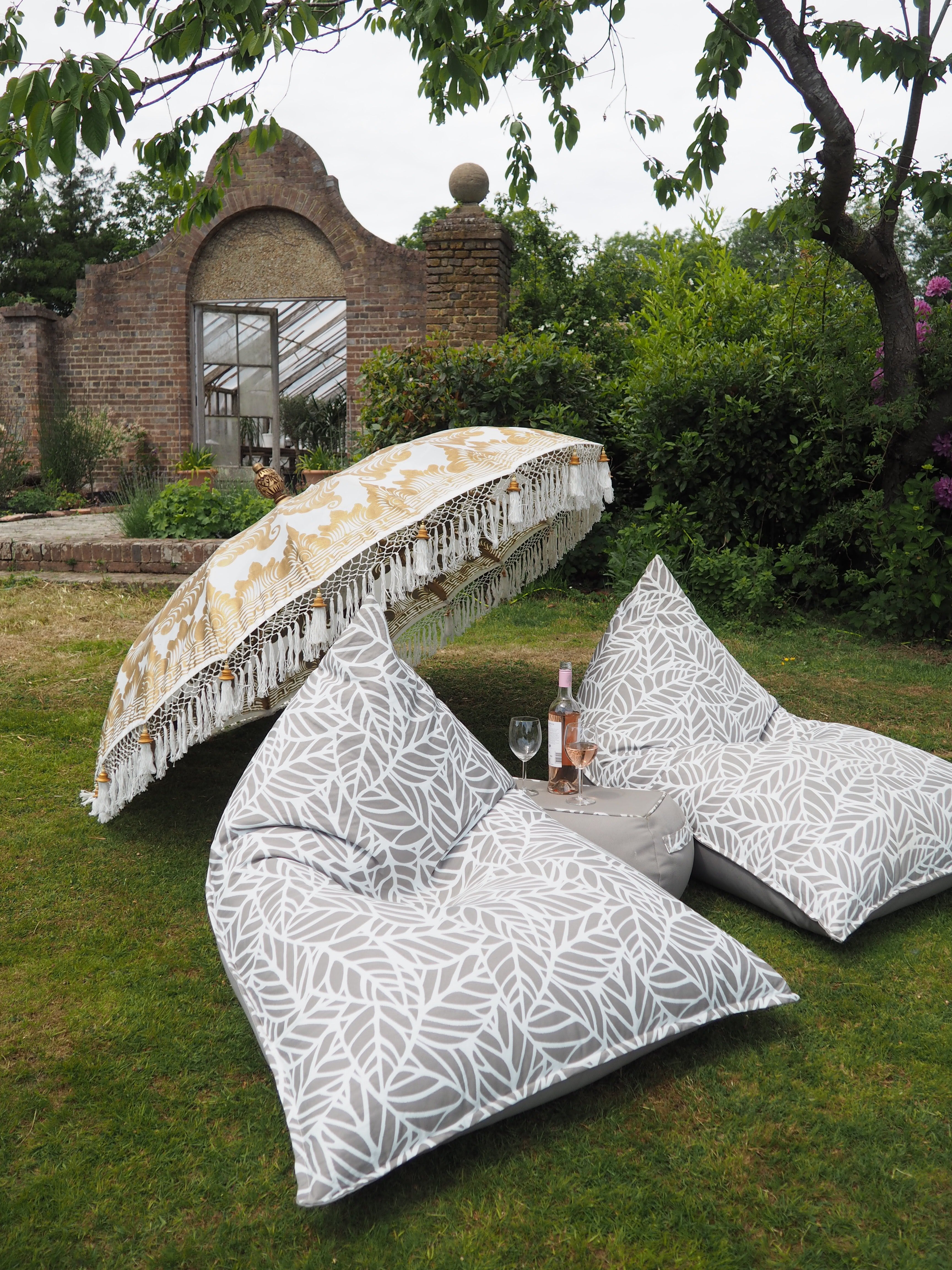 Two outdoor bean bag loungers look inviting on the lawn