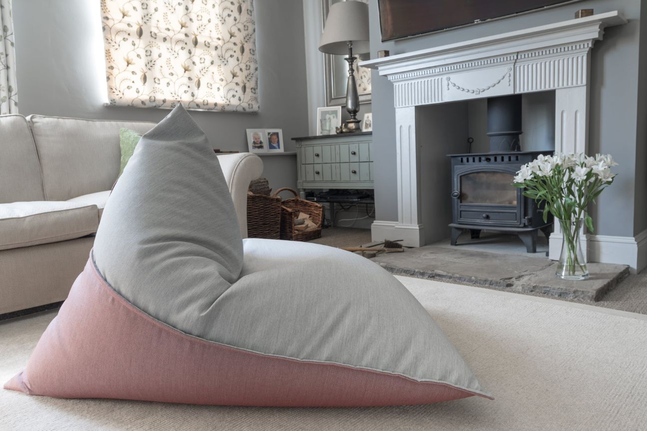 A teardrop-shaped bean bag chair looks stylish and inviting in the centre of a beautiful living room.