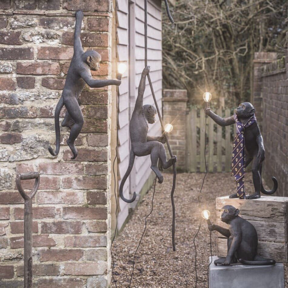 Outdoor lights in the shape of monkeys light the way for an elegant Halloween garden party