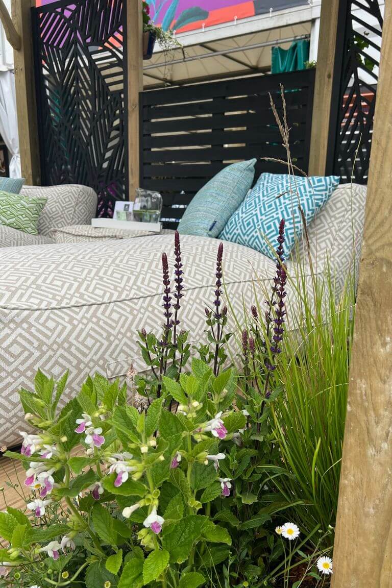 A luxury fabric cushioned sun lounger is made extra inviting with a turquoise patterned outdoor cushion