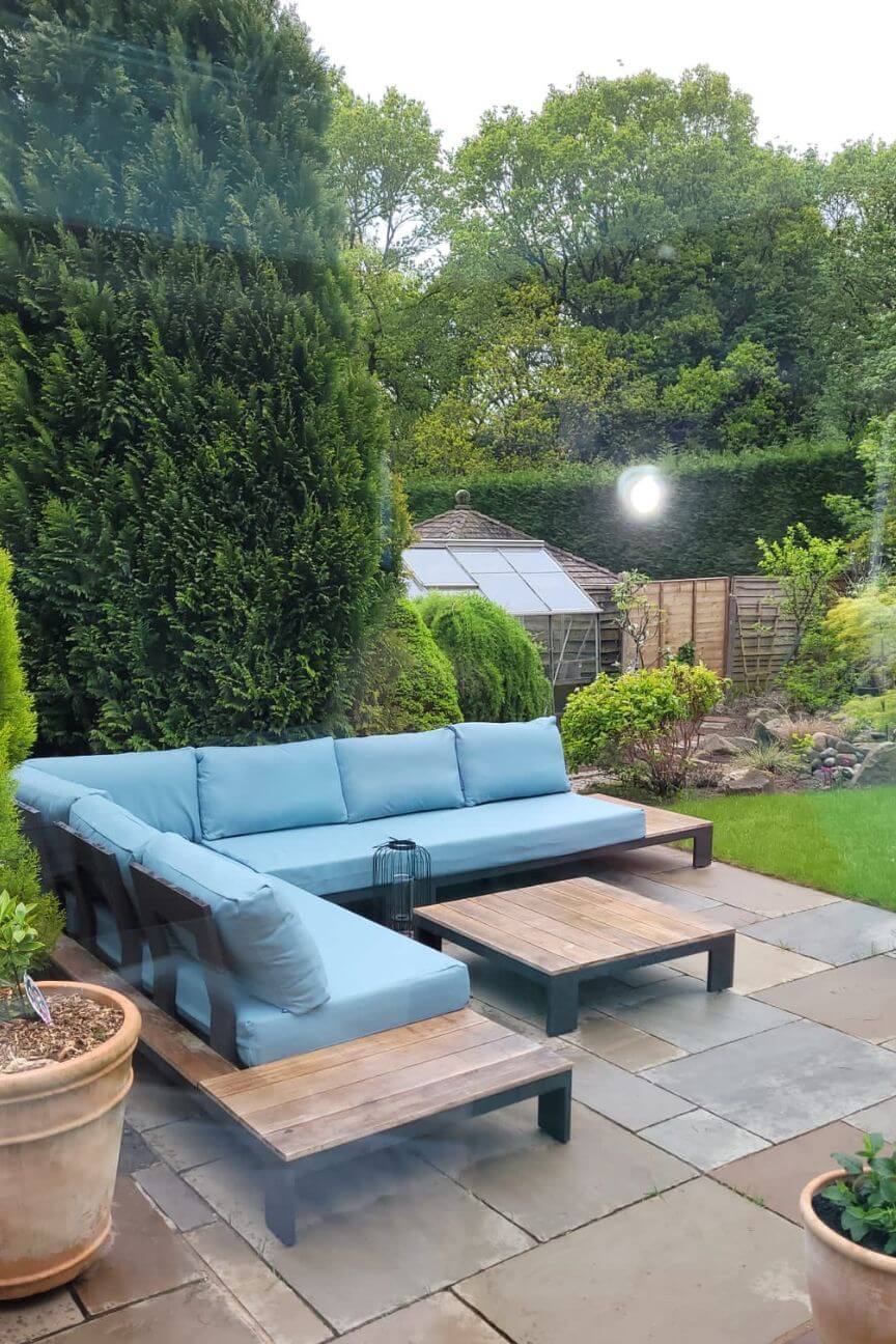 Outdoor sofa with made-to-measure ocean blue cushions on a patio