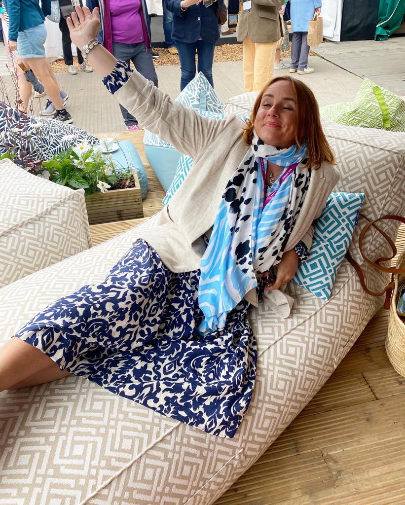 Sally from Getting Stuff Done in Heels relaxing on a luxury sun lounger from Armadillo Sun at the RHS Chelsea Flower Show 2022