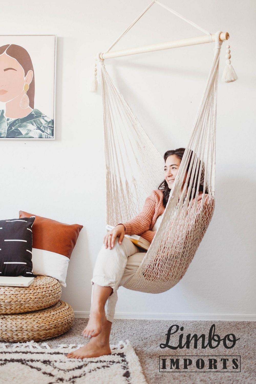 woman sitting on an indoor macrame hammock swing chair that is hanging from the ceiling