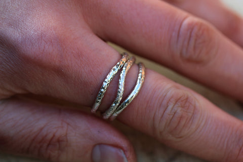 set of three wavy stacking rings on finger 