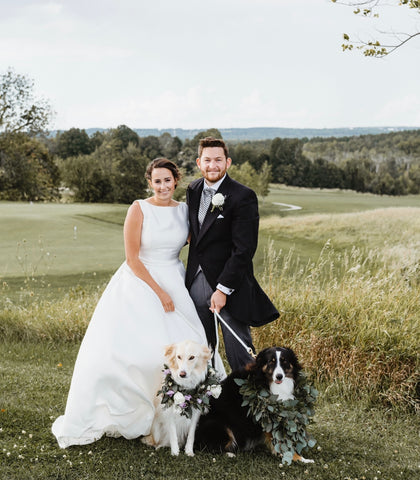 Wedding with two dogs wearing flower garlands