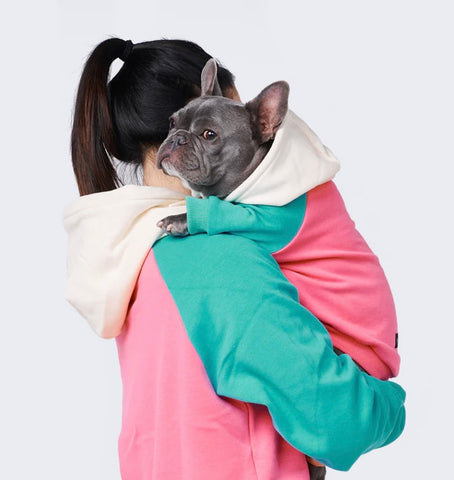 Owner and dog wearing matching sweatshirts