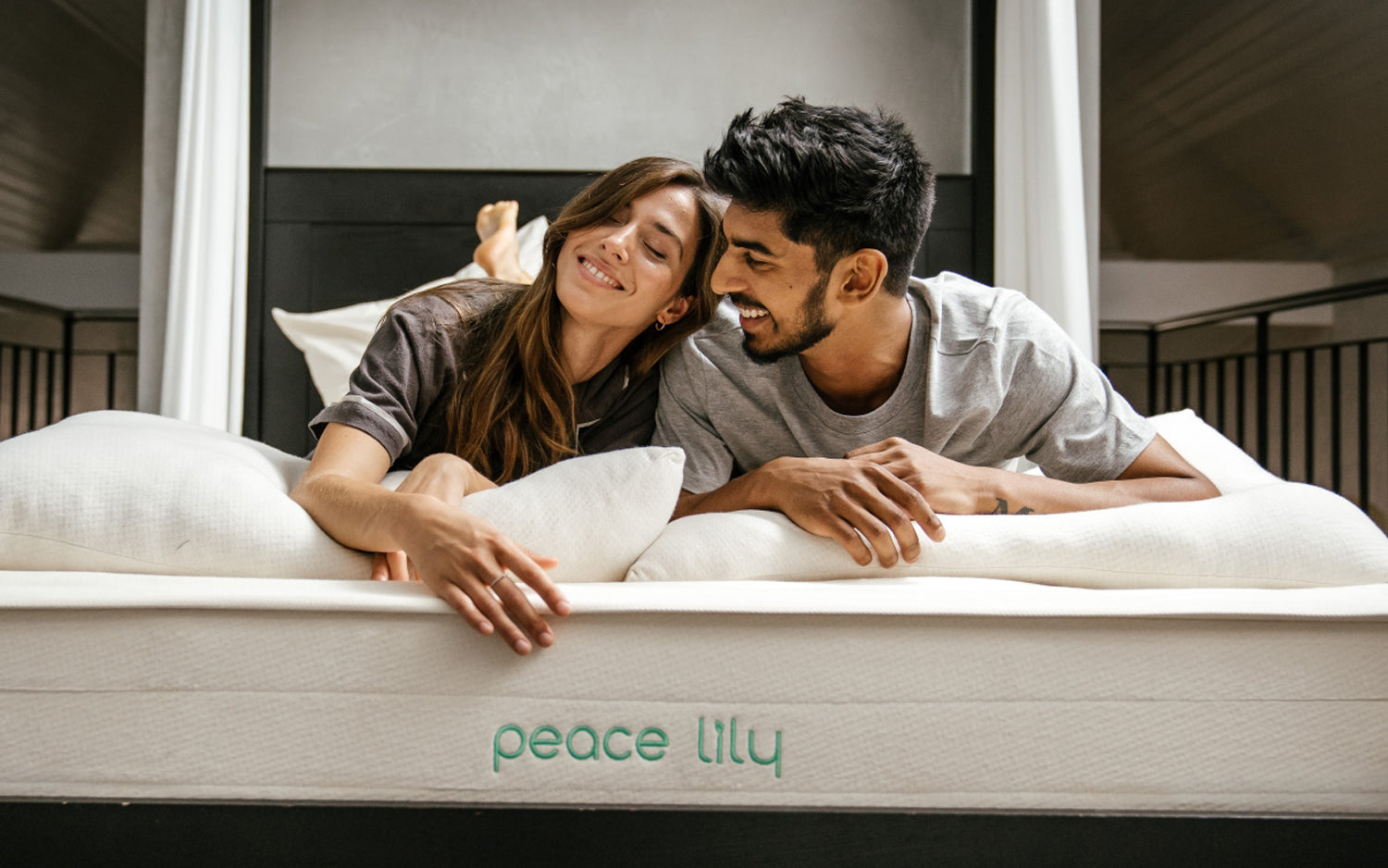 Two people sleeping on top of a natural Peace Lily latex mattress