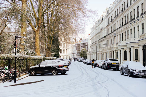 A london street with cars covered in snow
