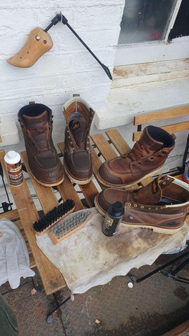 Gently brushing a brown leather boot with a soft-bristled brush - Touchy Style