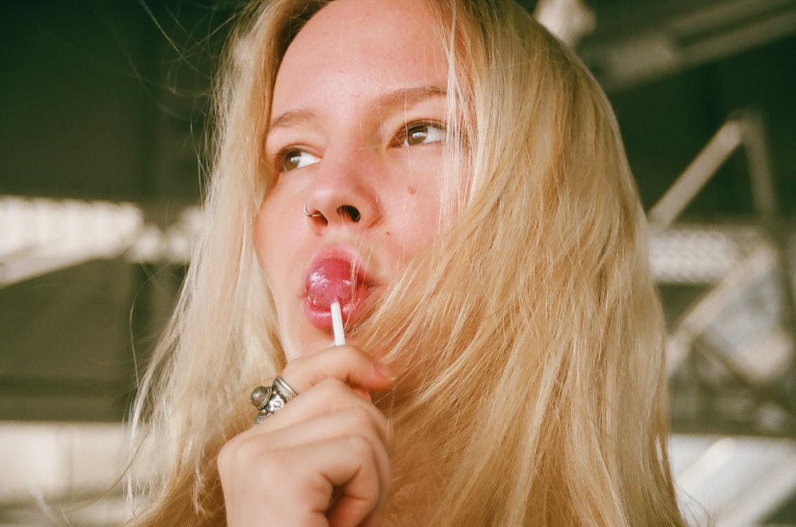 Woman Licking Lollipop