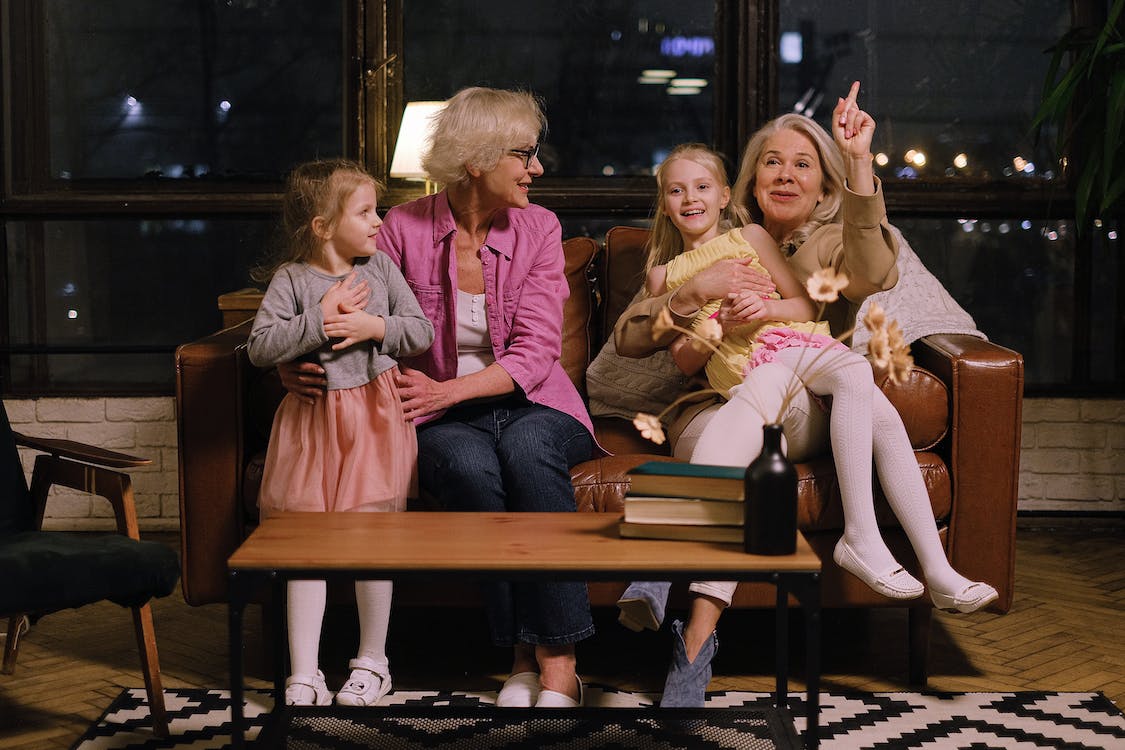 Women Sitting on a Couch with their Granddaughters
