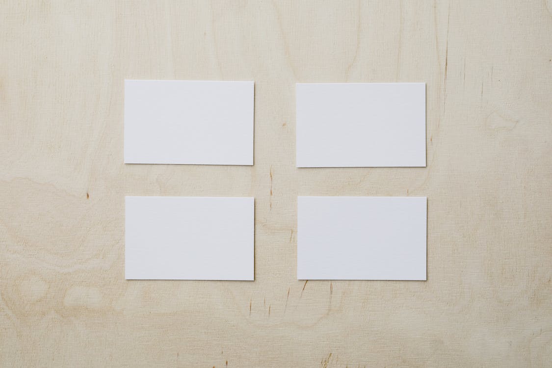 Empty white business cards on wooden table